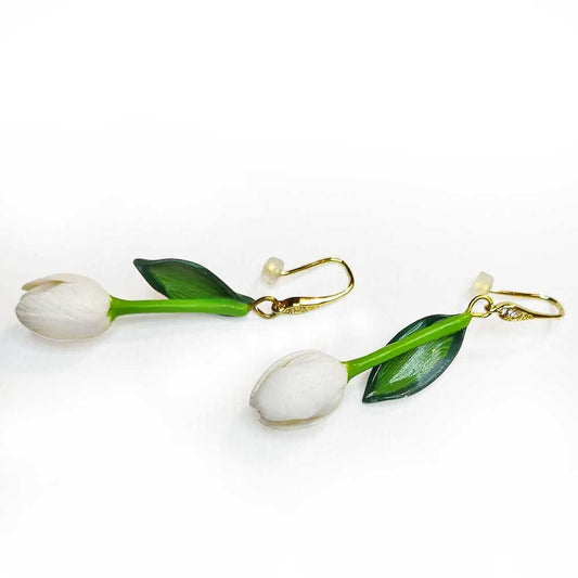 A pair of handcrafted polymer clay tulip earrings with gold-colored ear hooks and green leaves, featuring white tulip flowers and two zirconia stones.